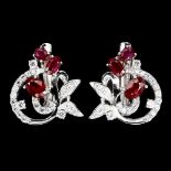 A matching pair of 925 silver earrings set with rubies and white stones, L. 2cm.