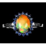 A 925 silver cluster ring set with cabochon cut opal and sapphires, (S).