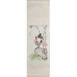 A Chinese watercolour painting mounted on a silk surround of a cockerel on a rock besides stems of