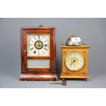 Two Edwardian wooden alarm clocks, tallest H. 23cm.