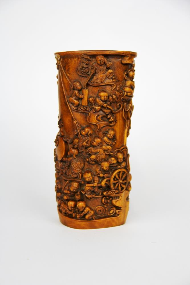 An intricately carved Chinese 'yellow wood' vase/brush pot decorated with children among clouds with
