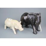 A carved Zimbabwe soap stone figure of a warthog, H. 27cm, together with a carved ebony elephant.