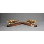 A pair of carved horn lions mounted on wooden bases, L. 23cm. One tail A/F.