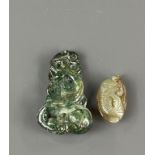 A 19th / early 20th C Chinese carved jade pendant, H. 5.5cm, together with a carved pebbled jade