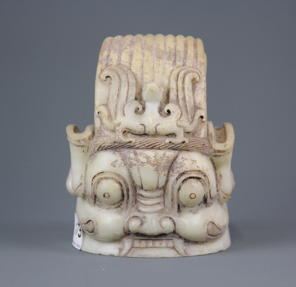 An interesting Chinese carved marble guardian deity head, H. 15cm. Dia. 11.5cm.