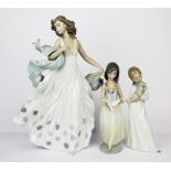 A large Lladro porcelain figure (A/F), H. 31cm, a Nao figure and a further Lladro figure.