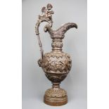 A superb 19th century Italian bronze jug shaped centrepiece decorated with putti, H. 57cm.
