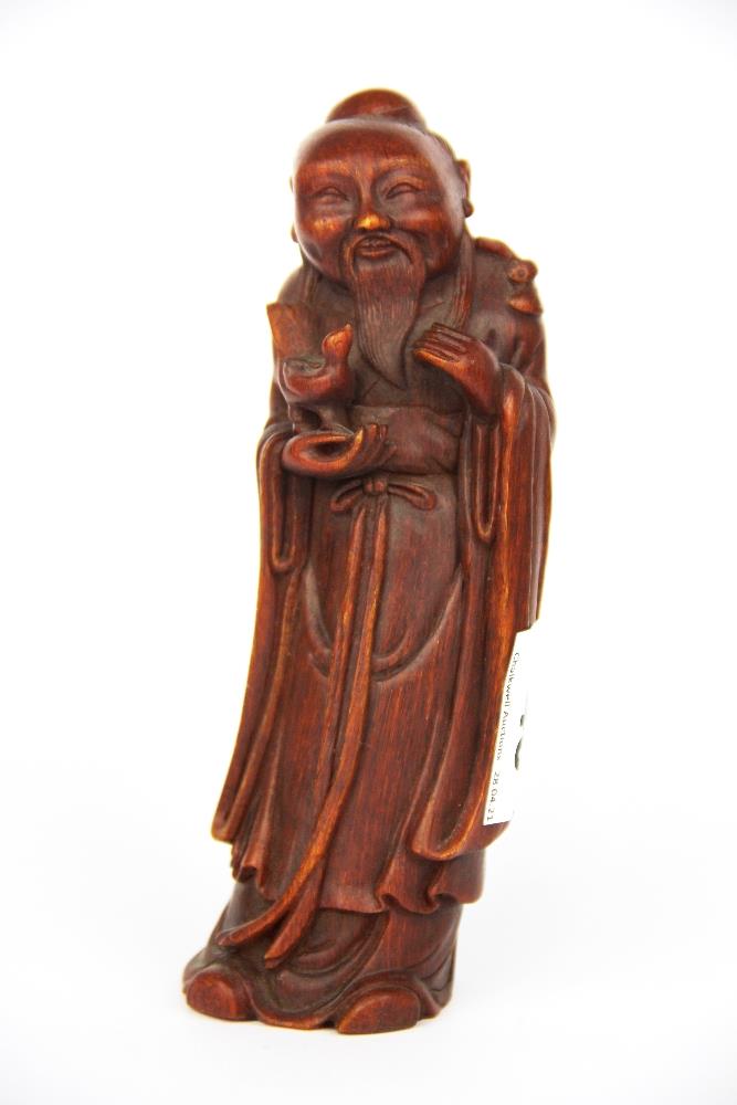 A Chinese carved horn figure of a deity, H. 18cm.