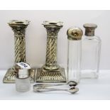 Three hallmarked silver topped dressing table items with a pair of silver candlesticks and sugar