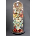 A tall Victorian hand made artificial flower display under glass dome, H. 57cm.