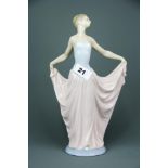 A Lladro porcelain figure of a girl in a pink dress, H. 30cm.