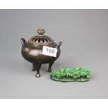 A Chinese bronze censer, H. 12cm. Together with a green dyed early 20th century carved ivory stand.
