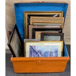 A metal travelling trunk with a quantity of framed pictures.