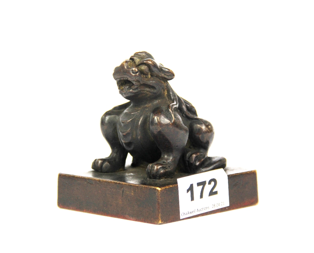 A Chinese bronze scholar's seal topped by a qilin figure, H. 9cm.