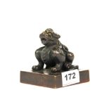 A Chinese bronze scholar's seal topped by a qilin figure, H. 9cm.