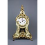 A wooden gilt metal and faux mother of pearl mantel clock by Berger of Paris, H. 41cm.