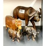 A carved hardwood water buffalo, H. 18cm, together with three other carved wood animals.