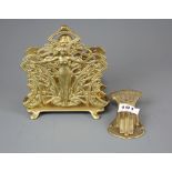 A Victorian brass letter clip and an Art Nouveau style letter rack.