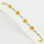 A 925 silver gilt bracelet set with round cut blue topaz, L. 20cm.