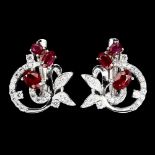 A pair of 925 silver earrings set with oval cut rubies and white stones, L. 1.8cm.