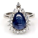 A 925 silver cluster ring set with a pear cabochon cut sapphire surrounded by white stones, (M).