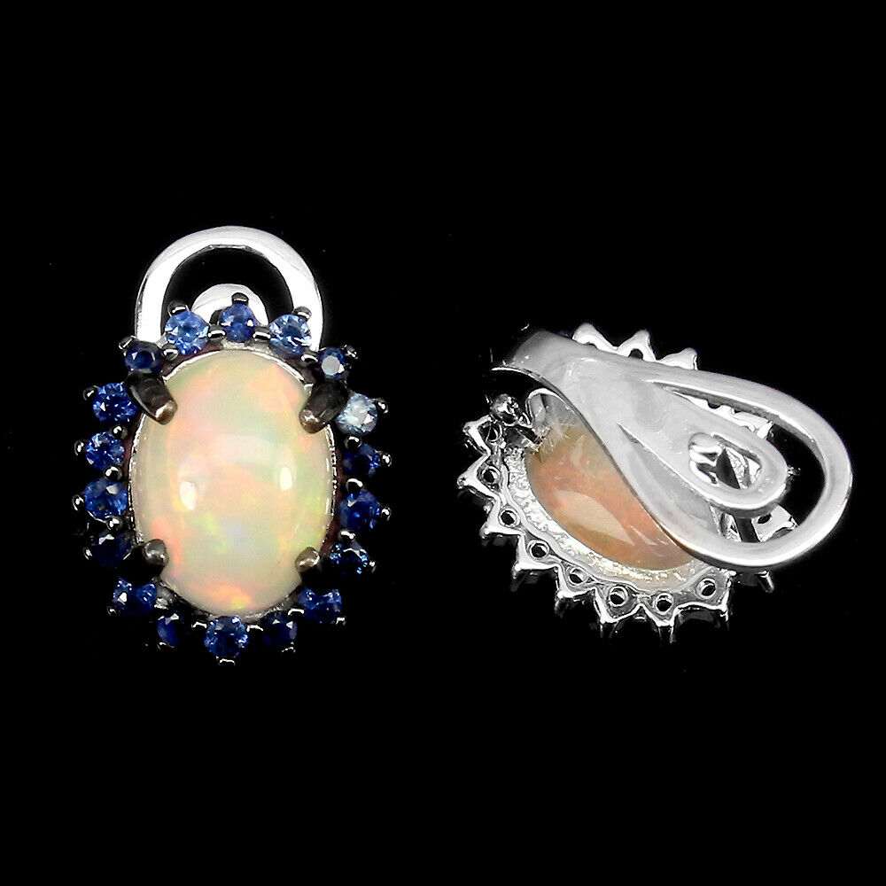 A pair of 925 silver earrings set with cabochon cut opals surrounded by sapphires, L. 1.6cm. - Image 2 of 2