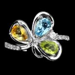 A matching 925 silver ring set with pear cut blue topaz, citrine and peridot, (O).
