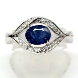 A matching 925 silver ring set with an oval cut sapphire and white stones, (O).