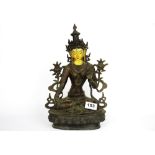 A Tibetan temple style copper bronze figure of a seated Tara with a hand painted face, H. 32cm.