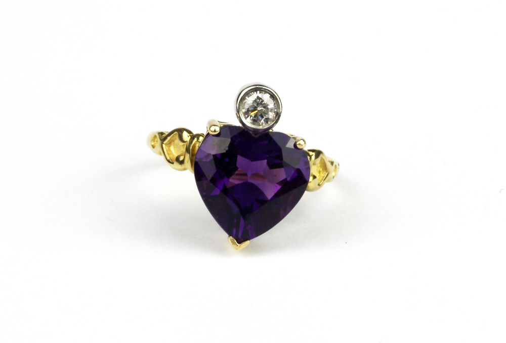 A yellow metal (test high carat gold) set with a heart cut amethyst and a brilliant cut diamond, (