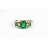 A 14ct yellow gold (stamped 14K and 585) ring set with baguette cut emeralds and brilliant cut