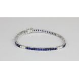 An 18ct white gold (stamped 750) bracelet set with princess cut sapphires and princess cut diamonds,