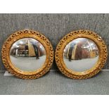 A pair of 1930's circular gilt plaster framed mirrors, Dia. 55cm. A/F