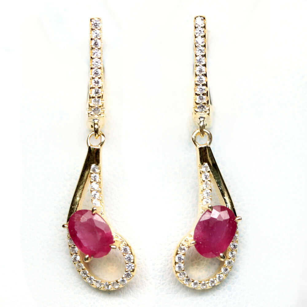 A pair of 925 silver gilt drop earrings set with oval cut rubies and white stones, L. 3.6cm.