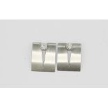 A pair of 18ct yellow and white gold (stamped 750) diamond set stud earrings, L. 1.5cm.