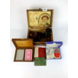 A box of mixed vintage playing cards and whist markers.