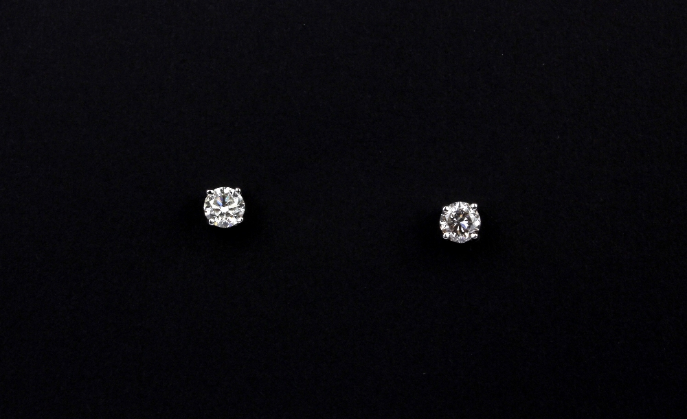 A pair of 18ct white gold (stamped 18k) stud earrings set with brilliant cut diamonds, approx. 0.