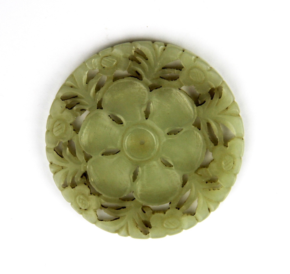 A 19th / early 20th century Chinese carved double sided nephrite jade flower panel, Dia. 5.5cm.