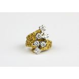 A heavy yellow metal (tested 18ct gold) crossover ring set with six brilliant cut diamonds,