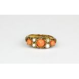 A 9ct gold ring set with cabochon cut coral and pearls, (K.5).