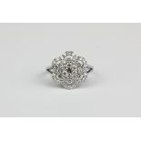 A 18ct white gold (stamped k18) flower shaped cluster ring set with brilliant cut diamonds,