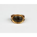A gilt metal (tested minimum 9ct gold) mourning ring with an oval shaped hair compartment, (J).
