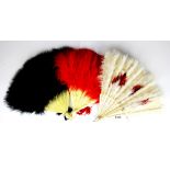An Oriental carved bone and ostrich feather fan together with two celluloid and ostrich feather