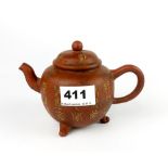 A Yixing terracotta teapot slip decorated with archaic characters, H. 11cm. Spout to handle 16cm.