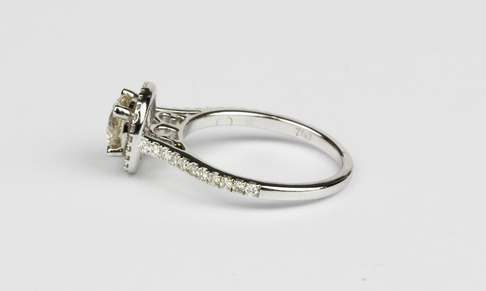 A 18ct white gold (stamped 750) halo ring set with a brilliant cut diamond and diamond set - Image 2 of 2