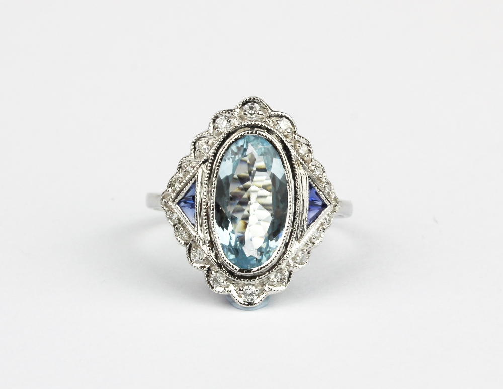 An 18ct white gold (stamped 18k) ring set with an oval cut aquamarine and sapphire and diamond set