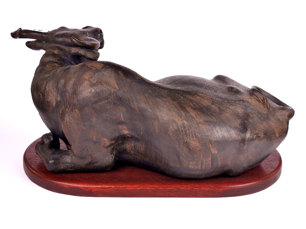 A Chinese bronze coloured terracotta figure of a water buffalo on a wooden pedestal, L. 46cm. - Image 2 of 3