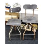 Two vintage machinist's swivel tubular metal chairs.