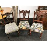 A pair of Edwardian carved mahogany hall chairs with a further hall chair upholstered with William
