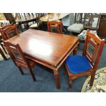 An Indian hardwood and wrought iron dining table and four chairs, 150 x 90cm.